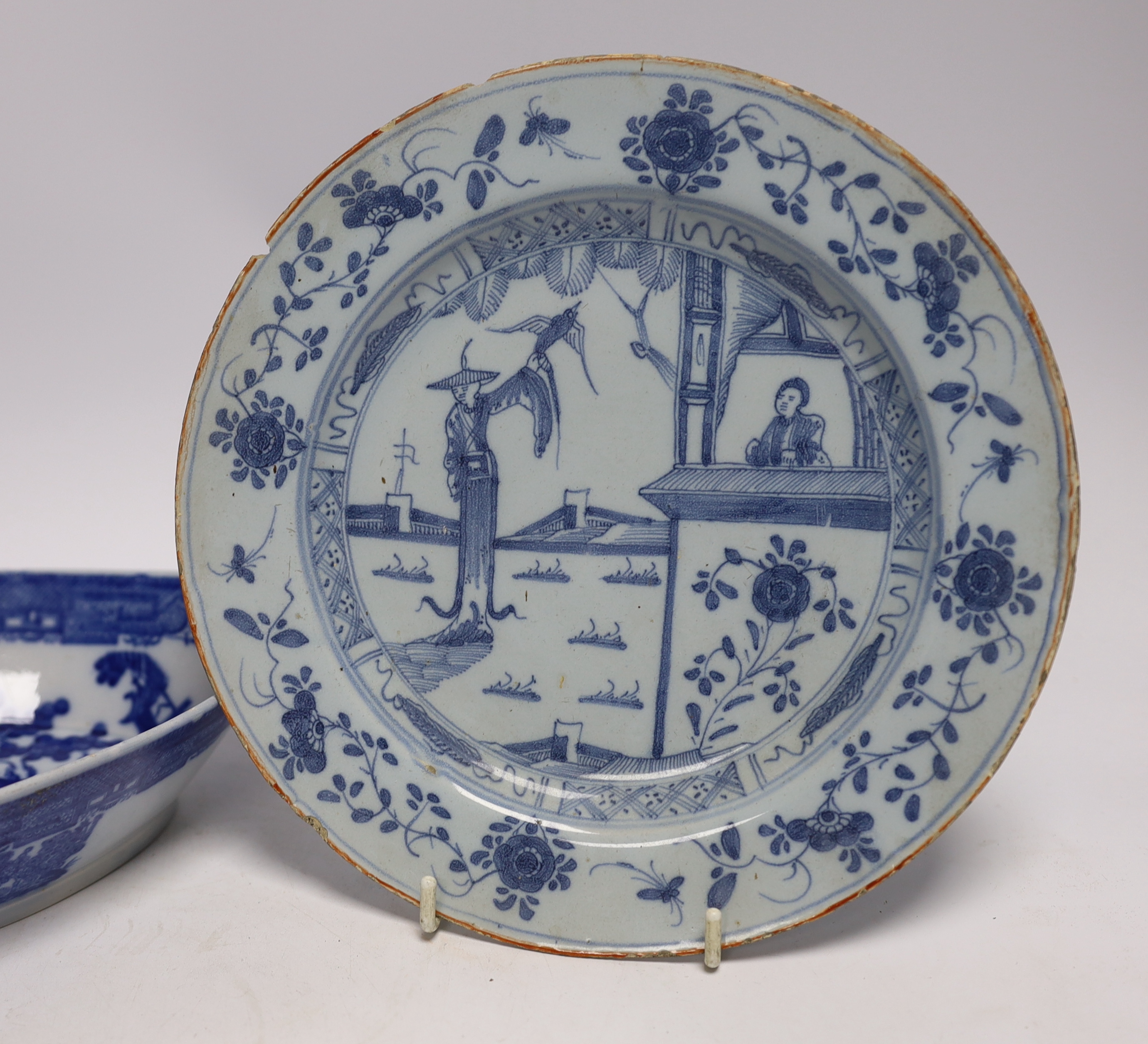 An 18th century delftware plate and blue and white pearlware plate, largest 28cm wide